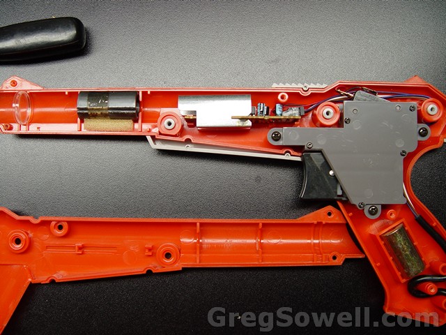 Guts of the zapper.  The only thing we care about here is the switch.  You can see all of the optical parts and the weights...it makes it feel more substantial.  