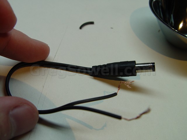 I cut the leads off of the wall wart.  The thick white striped wire is the center positive.  If you are unsure you can always use your continuity tester.